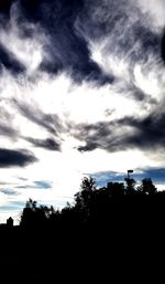 Low angle view of silhouette trees against sky at dusk