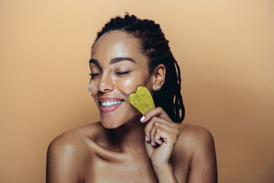 Portrait of shirtless young woman with eyes closed