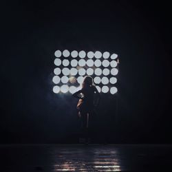 Full length of woman standing in illuminated park