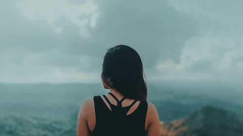 Rear view of woman looking at sea against sky