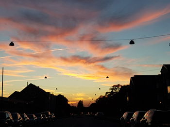 Cars on street at sunset