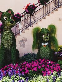 Flowers in statue against built structure