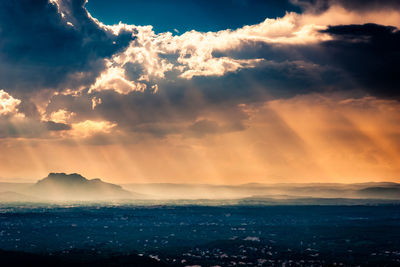 Scenic view of dramatic sky over landscape