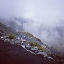 Scenic view of mountains against cloudy sky