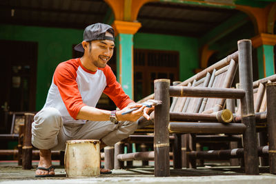 Portrait of young man sitting on chair