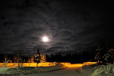 Scenic view of snowy landscape against sky at night