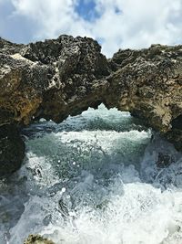 Scenic view of sea against cloudy sky