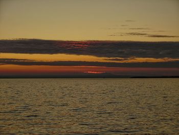 Scenic view of sea against romantic sky at sunset