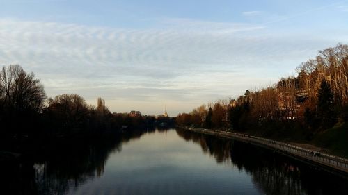Reflection of trees in water against sky
