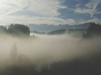 Scenic view of mountains against cloudy sky