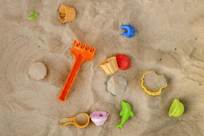 High angle view of various toys on sand