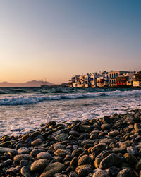 Scenic view of sea against clear sky at sunset