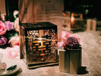 Close-up of illuminated tea light candles on table