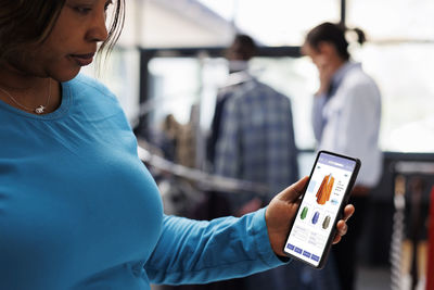 Midsection of woman using mobile phone