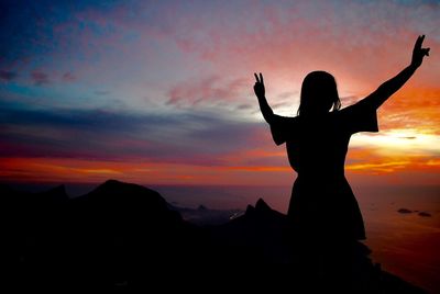 Silhouette of woman at sunset