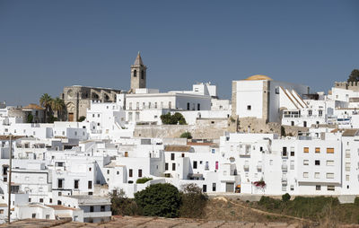 Buildings in city against clear sky