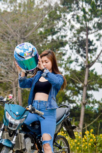 Side view of young woman riding bicycle