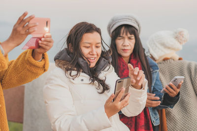 Group of people holding smart phone
