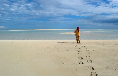 A girl walk alone on the beach 