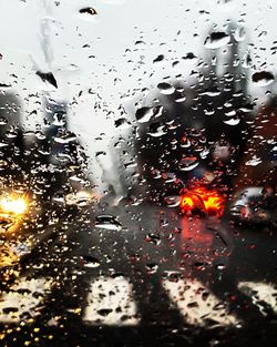 Full frame shot of wet glass window in rainy season