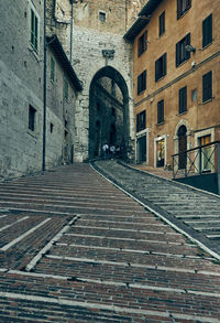 Empty alley amidst buildings in city