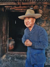 Portrait of man wearing hat standing outdoors