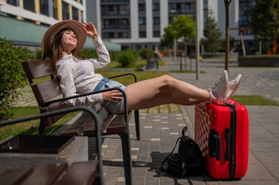 Full length of woman sitting on chair