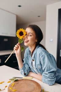 Midsection of woman holding flowers