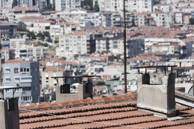 A roof with two chimneys and the city of izmir 