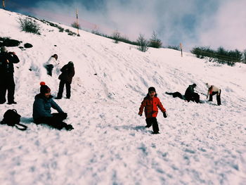 People on snow covered field