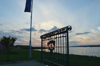 Built structure by lake against sky