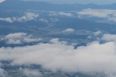Aerial view of clouds over mountains
