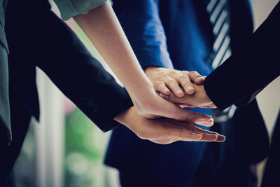 Midsection of couple holding hands