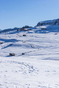 Scenic view of snowcapped mountains against clear blue sky