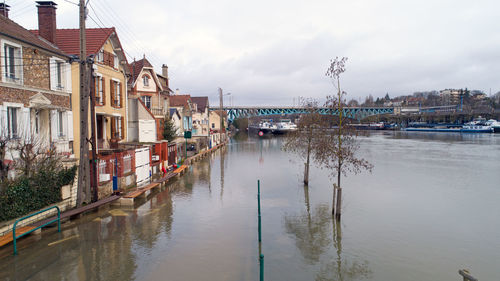 Houses by flooded canal