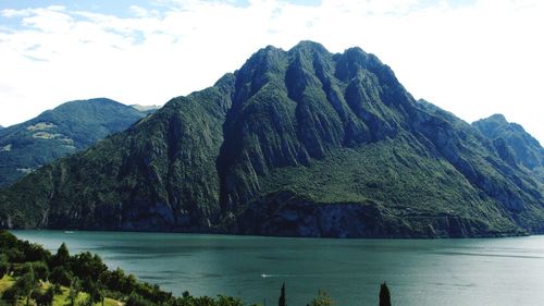 Scenic view of sea and mountains against sky