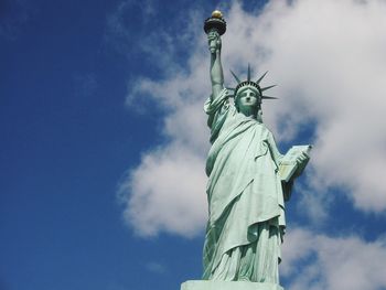 Low angle view of statue against cloudy sky