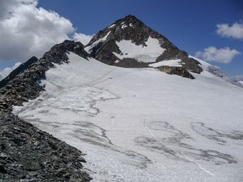 Low angle view of snowcapped mountains against sky