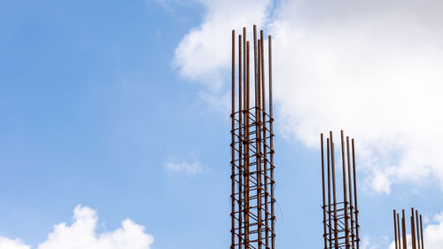 Low angle view of crane against blue sky