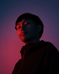 Portrait of boy looking away against sky during sunset