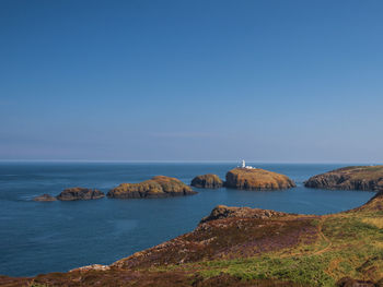 Scenic view of sea against clear blue sky