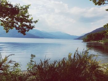 Scenic view of lake against cloudy sky