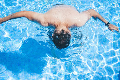 High angle view of man swimming in pool