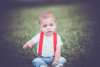 Portrait of cute girl sitting on land