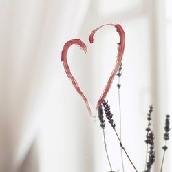 Close-up of heart shape against white wall