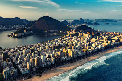 Panoramic shot of city by sea against sky