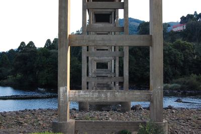 Built structure by trees against sky