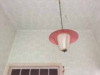 Low angle view of electric lamp hanging on ceiling