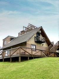 Low angle view of house on field against sky