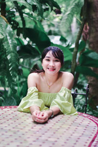 Portrait of a smiling girl sitting outdoors